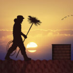 a chimney sweep in a sunset