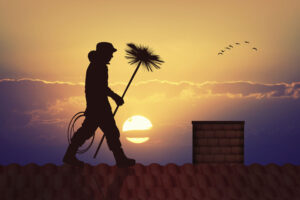 a chimney sweep in a sunset