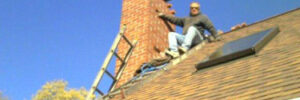 Workers working on maintaining a home chimney