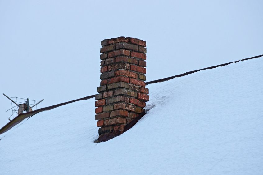 Old Chimney on Roof Surrounded by Snow