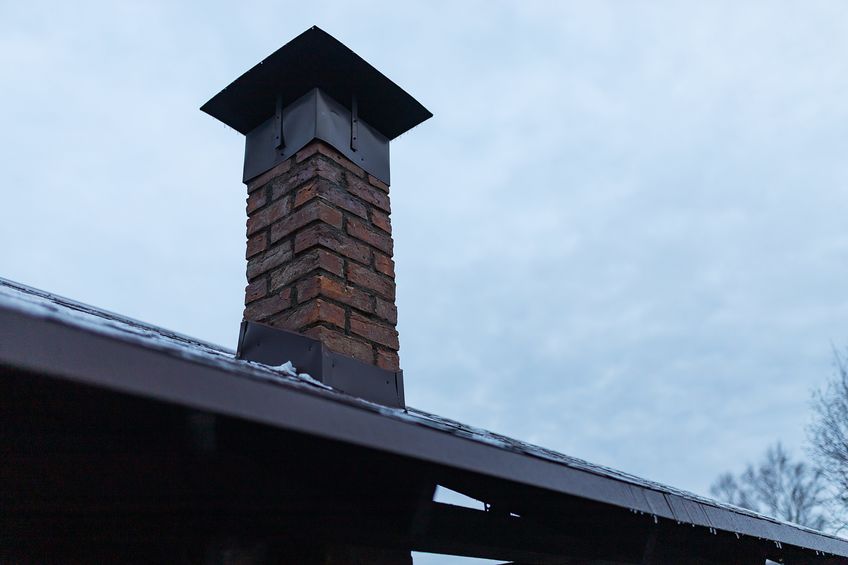 Old brick chimney that is leaning