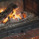 logs beautifully burn with a bright flame in the fireplace fire in a dark room