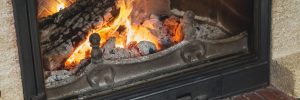 logs beautifully burn with a bright flame in the fireplace fire in a dark room