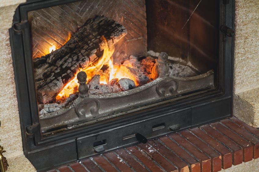 logs beautifully burn with a bright flame in the fireplace fire in a dark room