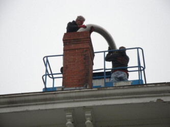 Workers installing chimney liner