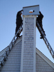 Workers repairing chimney