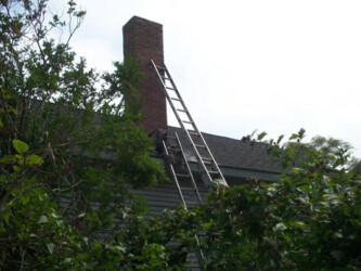Ladders being used for chimney repair